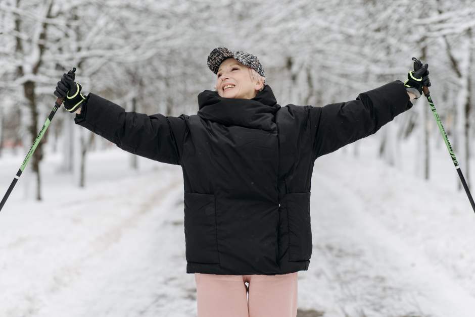 elderly woman triumphantly holding ski poles How to Not Let a Midlife Crisis Stop You From Living Your Best Life honeybunnytwee